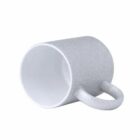 Gray ceramic mug lying on its side, handle facing forward, on a white background.