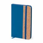Blue notebook with a cork accent and an elastic band closure, standing upright.