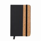 Closed notebook with a black cover, cork accent, and a black elastic band.