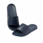 A pair of dark blue slide sandals, one standing upright and the other lying flat.