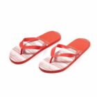 Red flip-flops with white soles featuring red horizontal stripes, on a white background.