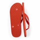 A pair of red flip-flops, one showing the sole and the other upright.