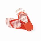 Red and white striped flip-flops with red straps on a white background.
