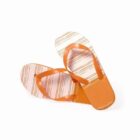 Orange and white striped flip-flops with overlapping soles on a white background.