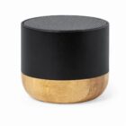 Small black and wood portable speaker with a mesh top, on a white background.
