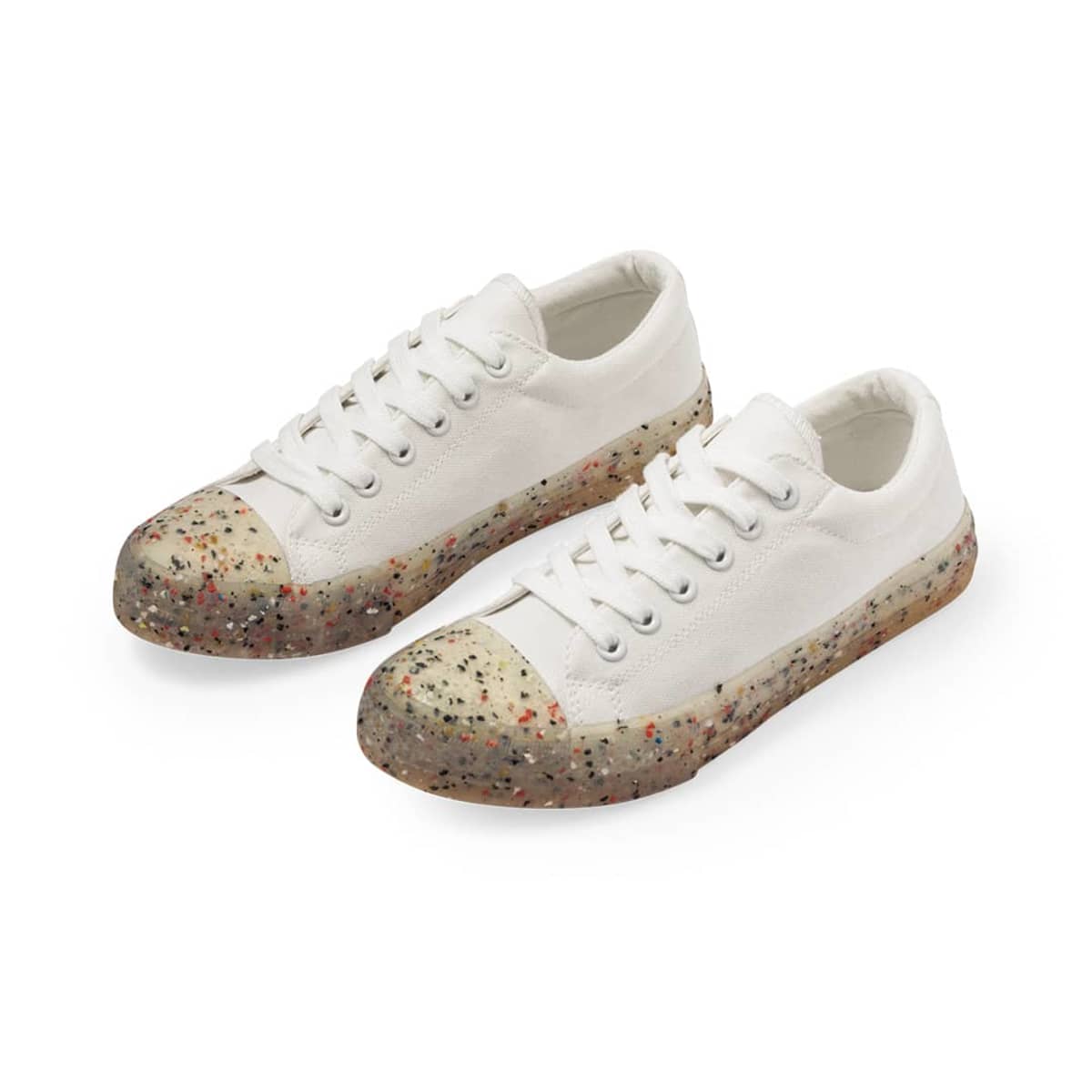 White canvas sneakers with speckled, translucent rubber soles and toe caps.
