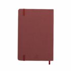 A closed brown notebook with rounded corners and a small cherry design on the cover.