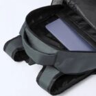 Open backpack with a laptop partially visible inside a padded compartment.