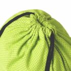 Close-up of a green mesh drawstring bag with black strings against a white background.