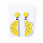 Yellow earrings shaped like lemon slices, displayed on a white card.