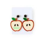 A pair of apple-shaped earrings with black seeds and a green leaf on each.