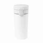 A white, cylindrical travel mug with a flip-top lid and a secure latch.