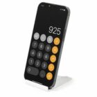 Smartphone on a stand displaying a calculator app with the number 925 on the screen.