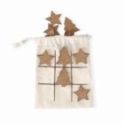 A tic-tac-toe game with cork stars and trees on a drawstring fabric bag.