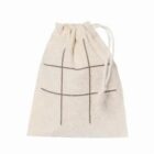 Beige drawstring bag with a tic-tac-toe grid design on the front.