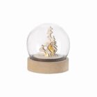 A glass dome with wooden trees and a deer scene on a round wooden base.