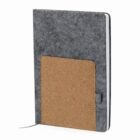 Gray notebook with a brown cork pocket on the front cover, standing upright.