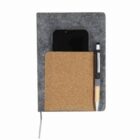 Gray notebook with cork pocket holding a phone and pen on a white background.
