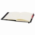 Open notebook with lined pages and a red pen resting on its cover.