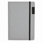 A gray notebook with a black elastic band running vertically along the right side.
