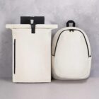 Two minimalist white backpacks with black accents against a light gray background.
