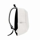 Side view of a white backpack with black accents and front pocket, on a white background.