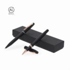 Two black pens with gold clips on a black box, with a recycled symbol in the corner.