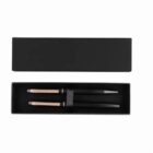 Black rectangular box open to show two black and gold pens inside.