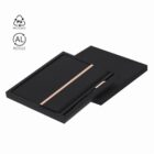 Black notebook and pen set in a black box, with recycled material symbols above.