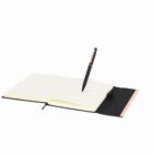 Open notebook with a pen standing vertically on its blank pages against a white background.