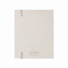 Closed beige notebook with subtle text and two elastic bands on the spine.
