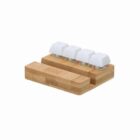 A small wooden keyboard with four white keys and a wooden wrist rest.