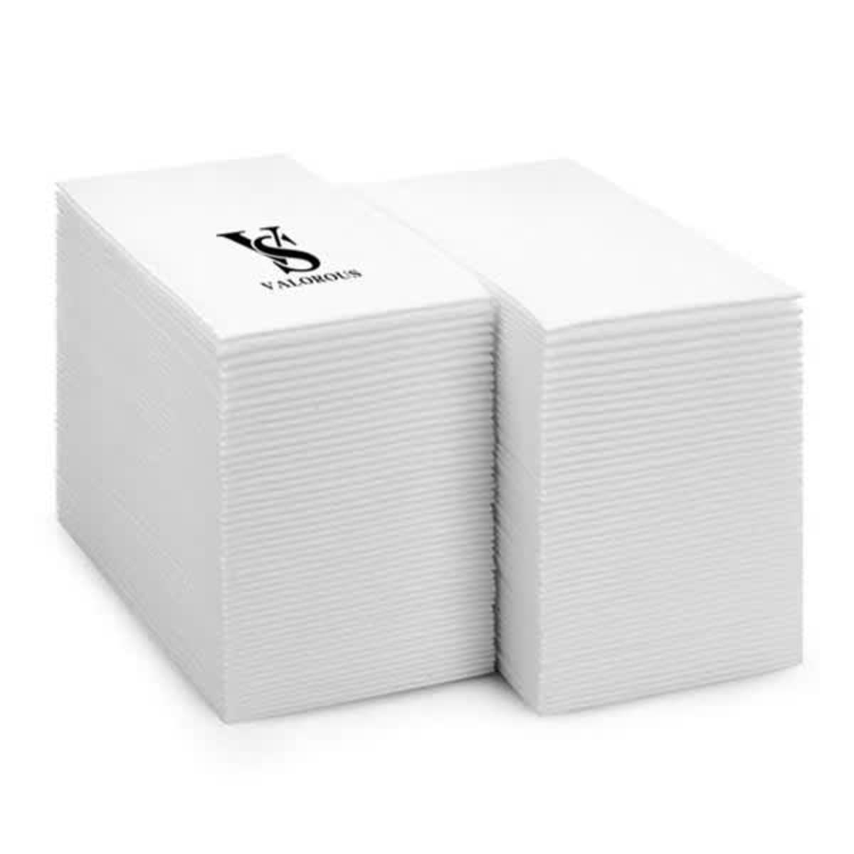 Two stacks of white paper napkins with a black VS logo on top.