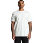 Man wearing a plain white t-shirt and black pants, standing against a white background.