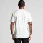 Man with tattoos wearing a plain white t-shirt and black pants, facing away.