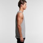 Man in a black and white striped tank top standing in profile against a plain background.
