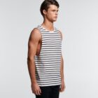 Man in a sleeveless white tank top with black horizontal stripes, standing sideways.