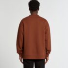 Person in a brown sweatshirt and black pants standing with their back to the camera.