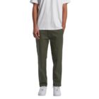Person wearing olive green pants, white t-shirt, and white sneakers, hands in pockets.