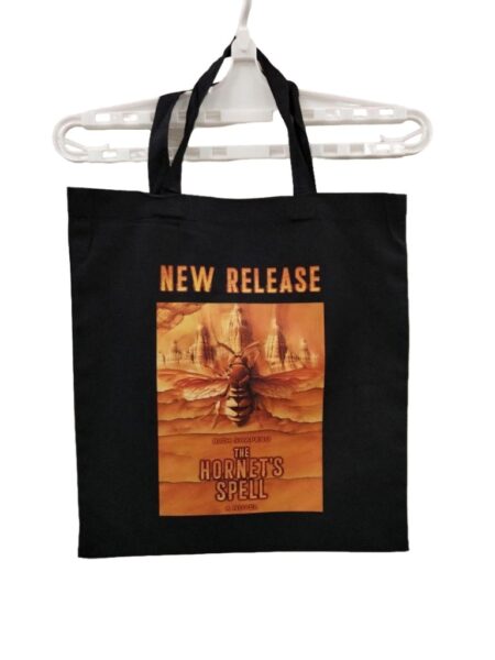 black tote bag printed with artwork and new release text