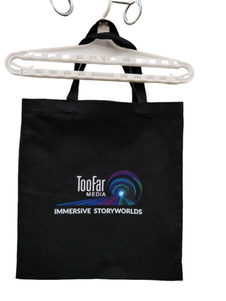 Black tote bag, hanging on a white hanger