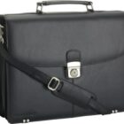 Black leather briefcase with a silver lock and adjustable shoulder strap.