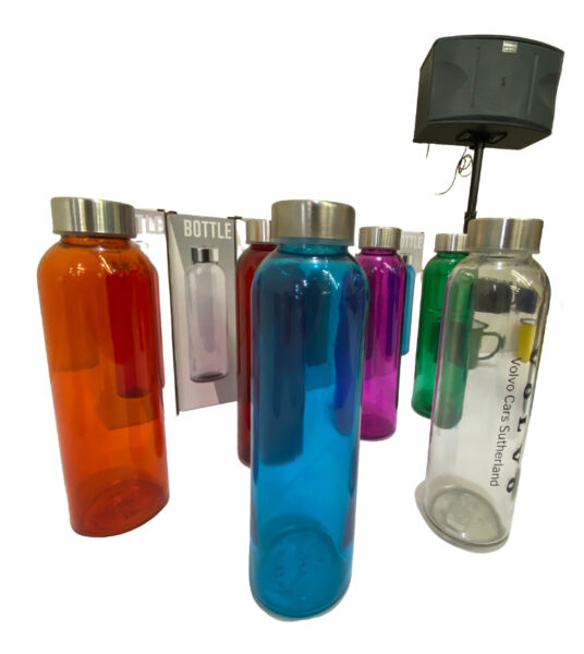 Colorful drink bottles with metal lids arranged by a speaker, offering real-world insights.