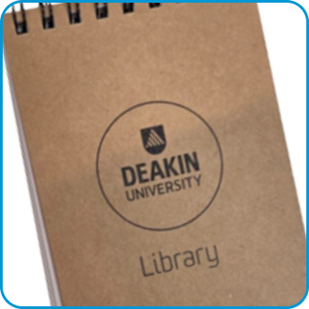 Brown spiral notebook with Deakin University Library logo on the cover.
