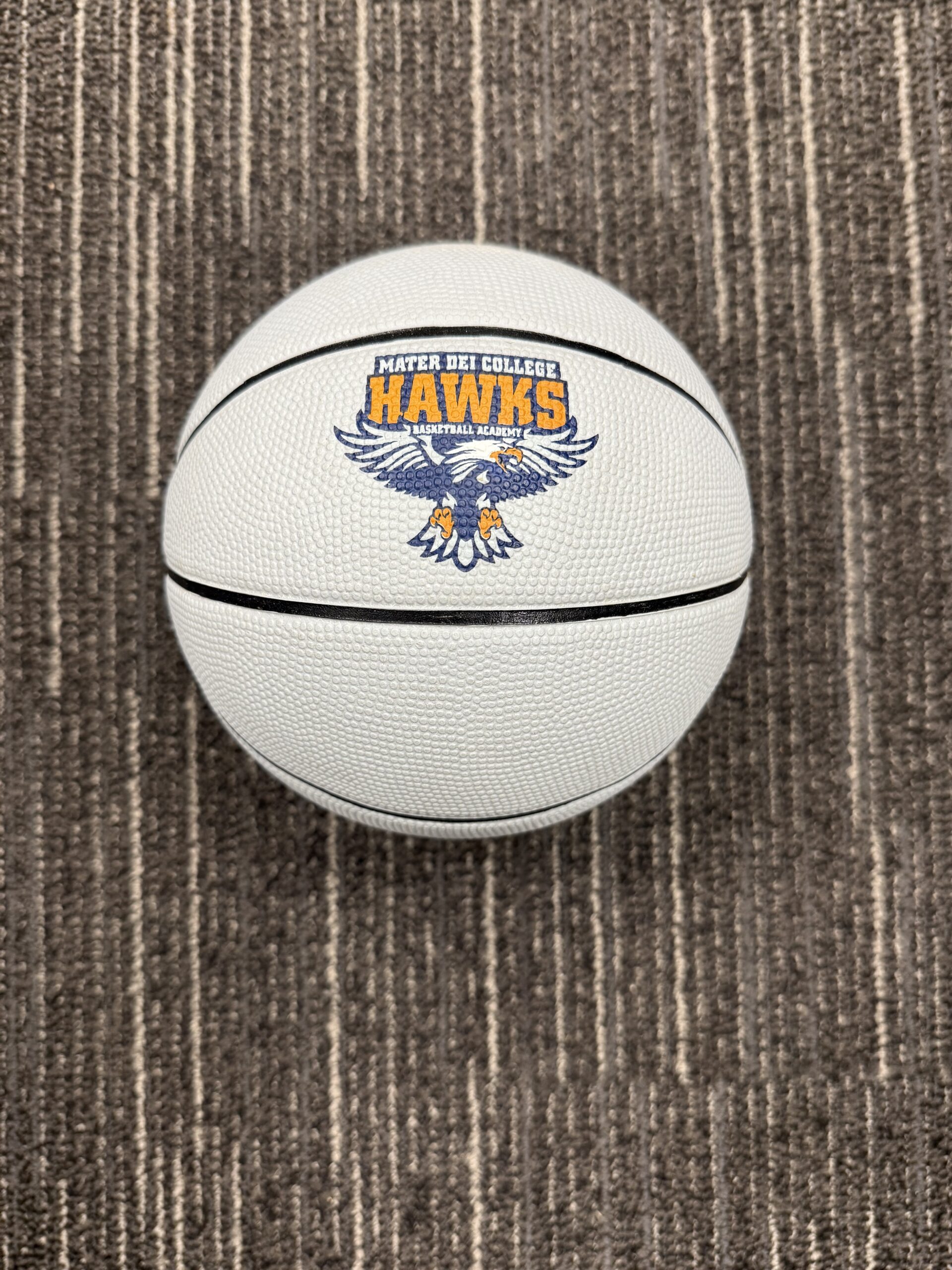 White basketball with the Mater Dei College Hawks Logo and a picture of a Hawk