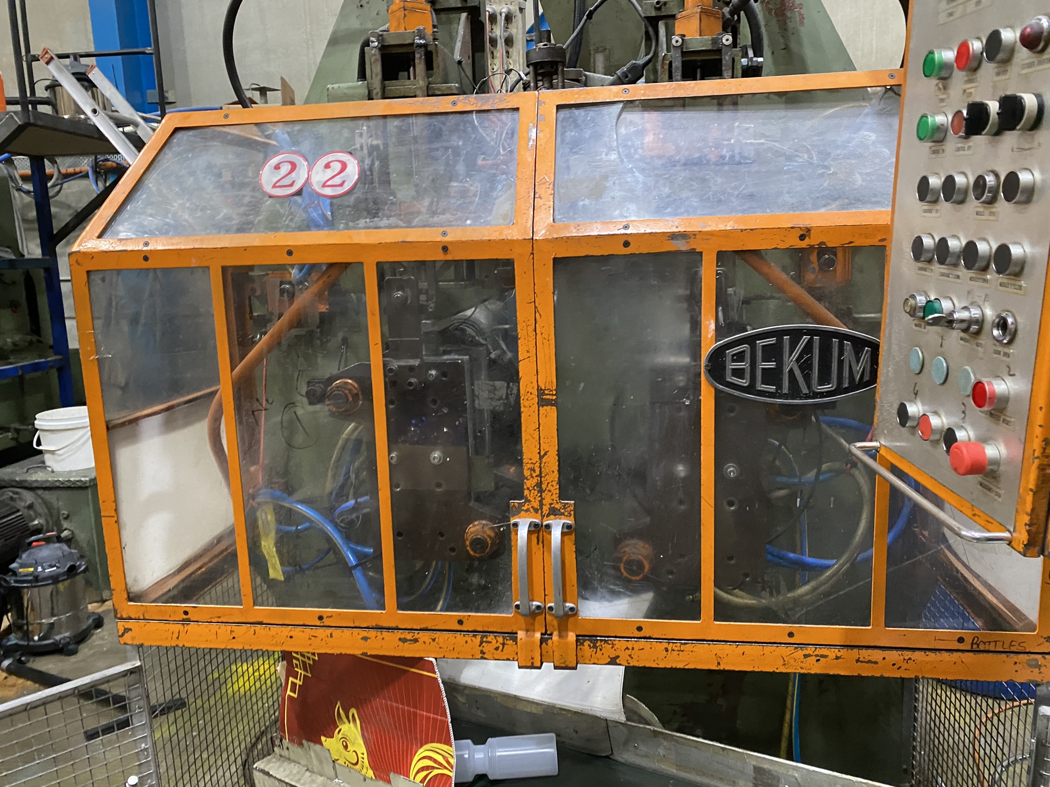 Orange-framed industrial machine for custom bottles with BEKUM label, Australian Made.