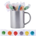 A silver mug holds colorful lollipops, with more lollipops lined up below it.