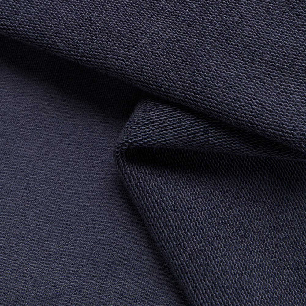 Close-up of premium quality dark navy knit fabric, perfect for a MADE Hoodie.