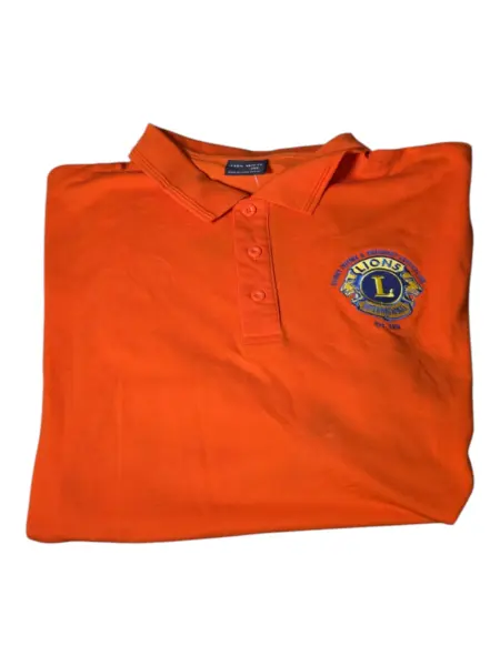 Folded orange polo shirt with Lions Club emblem