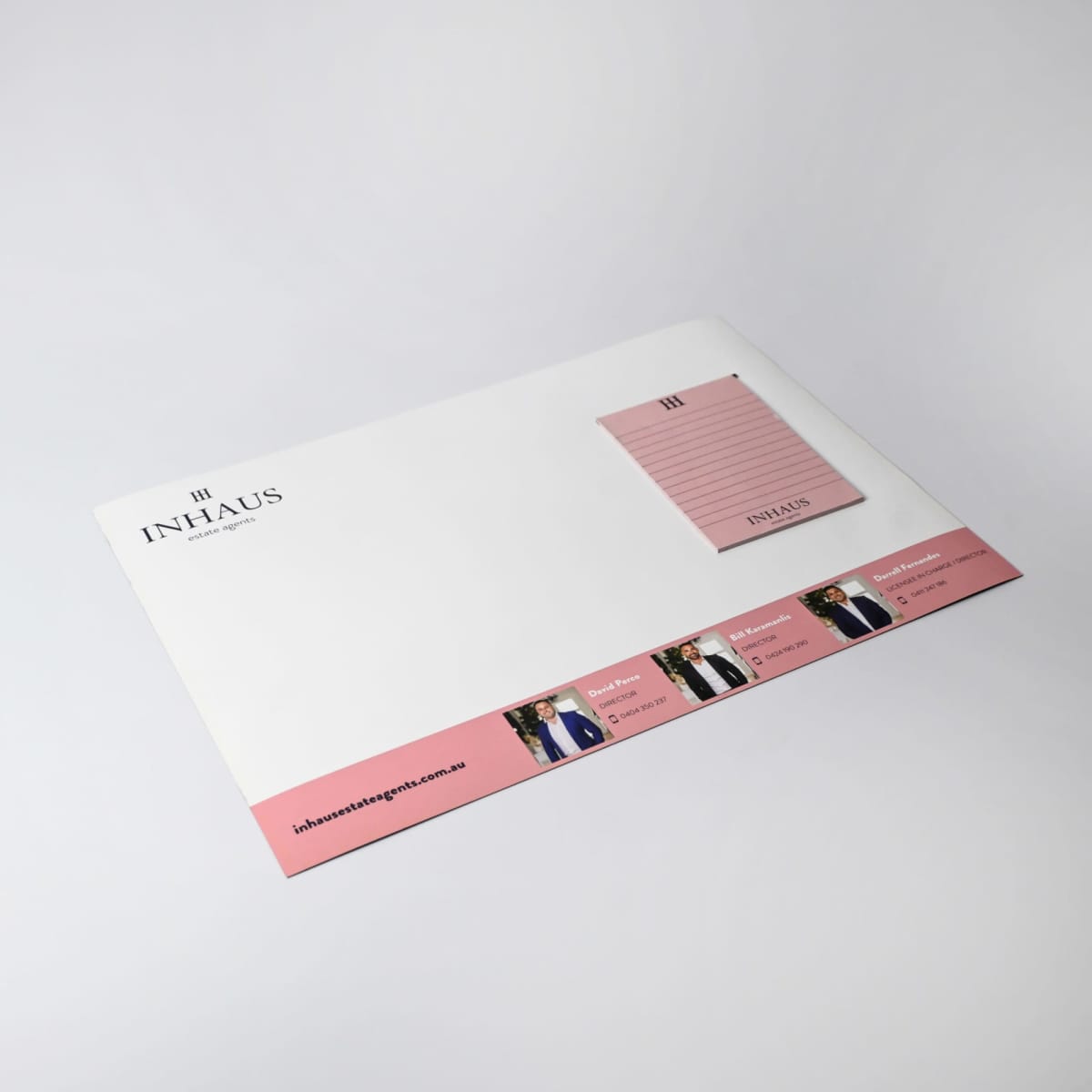 Promotional A3 Magnetic Whiteboard w/ Notepads, pink & white with INHAUS logo on the edge.